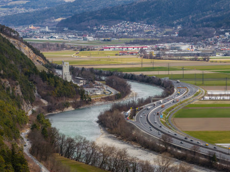 Austrian Alps with River, Highway, and Stone Towerの写真素材
