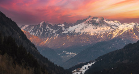 Aerial View of Dolomites at Sunset with Snow Capped Peaks and Villageの写真素材