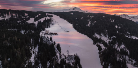 Aerial View of Snowy Alpine Landscape with Ski Slope in Dolomitesの写真素材