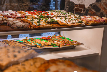Food Display with Pizzas and Cookies in Old Town Bergamo Shopの写真素材