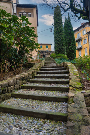 Cobblestone Staircase and Historic Buildings in Bergamo, Italyの写真素材