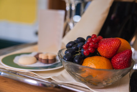 Close Up of Fruit Bowl with Cookies and Chocolates in Cozy Settingの写真素材