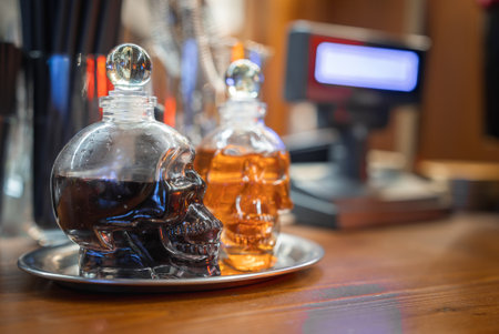 Skull Shaped Bottles on Silver Tray in Boutique Hotel Barの写真素材