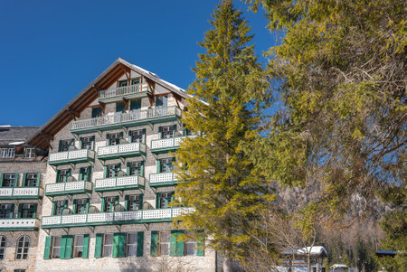Alpine Style Building with Green Shutters Near Braies Lake in Winterの写真素材