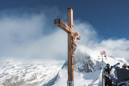 Wooden Crucifix with Snow Covered Mountains in Zermatt, Switzerlandの写真素材
