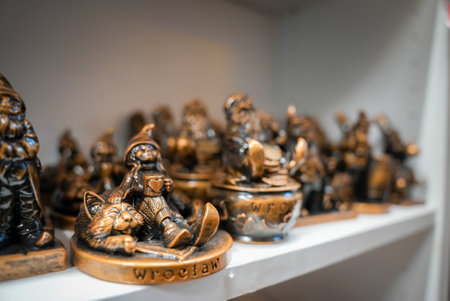 Bronze Gnome Figurines Displayed on a White Shelf in Wroclawの写真素材
