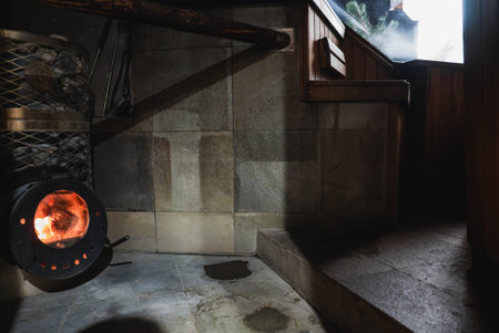 Rustic Interior with Wood Burning Stove and Stone Tiled Wallsの写真素材