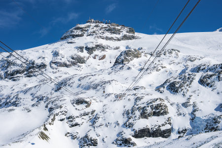 Snow Covered Mountain Peak with Ski Lifts in Zermatt, Switzerlandの写真素材