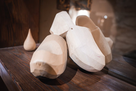 Close Up of Carved Wooden Clogs on Polished Wooden Surfaceの写真素材