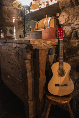 Rustic Interior with Guitar and Timber Bar in Italian Alpine Hotelの写真素材