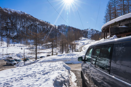 Snowy Mountain Landscape with Black Van in Italian Alpsの写真素材