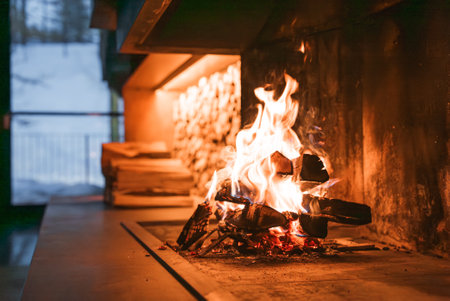 Modern Fireplace with Snowy Alpine View in Italian Alpsの写真素材
