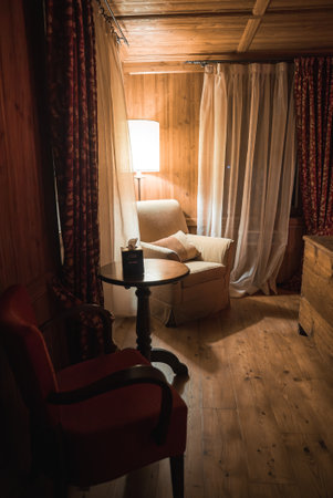 Cozy Interior of Luxury Alpine Hotel Room with Wooden Panelingの写真素材