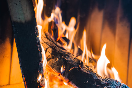 Close Up of Burning Log with Flames in Fireplace Interiorの写真素材