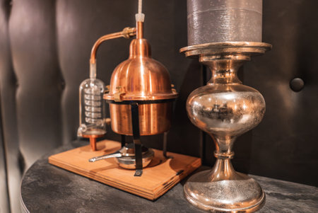 Copper Distillation Apparatus with Metallic Decor on Wooden Baseの写真素材