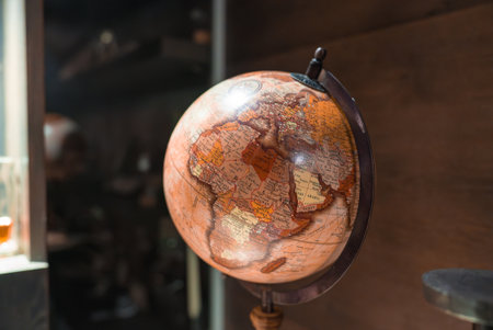 Vintage Globe on Wooden Stand in Refined Indoor Settingの写真素材