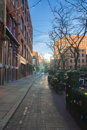 Manchester Street Scene with Red Brick Buildings and String Lightsの写真素材