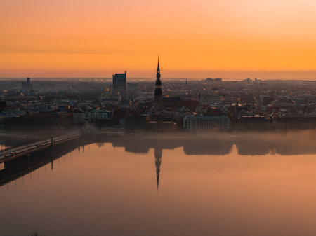 Sunrise Over Rigas Old Town with St. Peters Church and Daugava Riverの写真素材