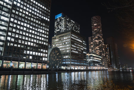 Nighttime View of Canary Wharf with Skyscrapers and Reflectionsの写真素材