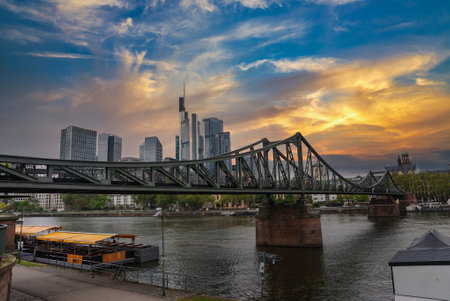 Eiserner Steg Pedestrian Bridge and Frankfurt Skyline Over Main Riverの写真素材