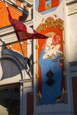 Relief of Virgin Mary and Baby Jesus on Brick Facade in Riga Old Townの写真素材