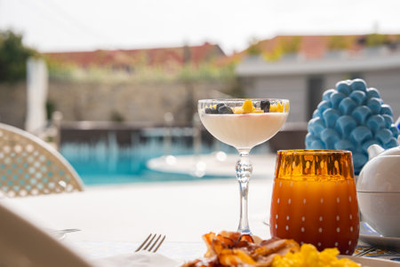 Outdoor Dining Table with Dessert and Food in Mediterranean Settingの写真素材