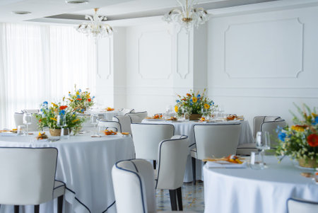 Elegant Dining Area with Chandeliers and Floral Centerpieces in Amalfiの写真素材