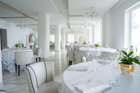 Elegant Dining Area with Marble Flooring and Large Windows in Amalfiの写真素材