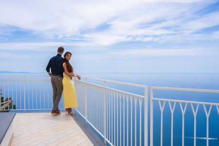Couple on Terrace Overlooking Tyrrhenian Sea on Amalfi Coastの写真素材