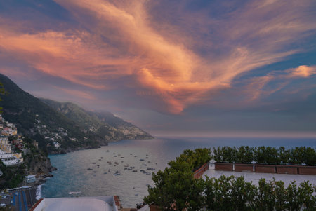 Sunset Over Positanos Colorful Hillside and Calm Blue Seaの写真素材