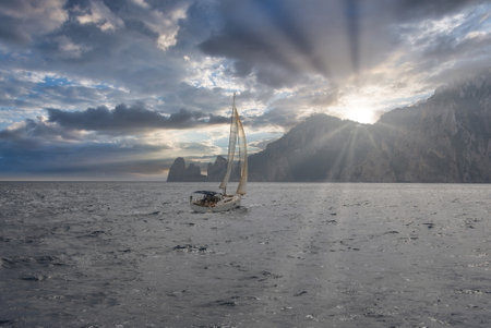 Sailboat Near Faraglioni Rock Formations on Capri Island, Italyの写真素材