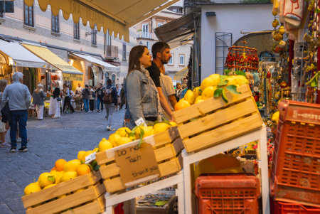 Lively Street Market in Amalfi with Crates of Vibrant Lemonsの写真素材