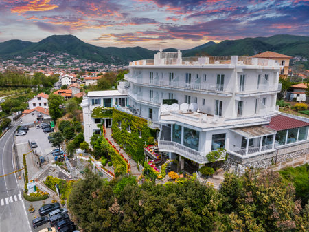 Luxurious White Hillside Hotel with Sunset and Rolling Green Hillsの写真素材