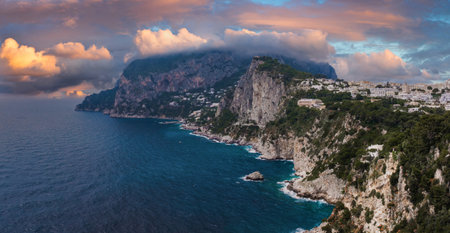 Coastline of Capri Island with Cliffs, Buildings, and Sunset Sky
