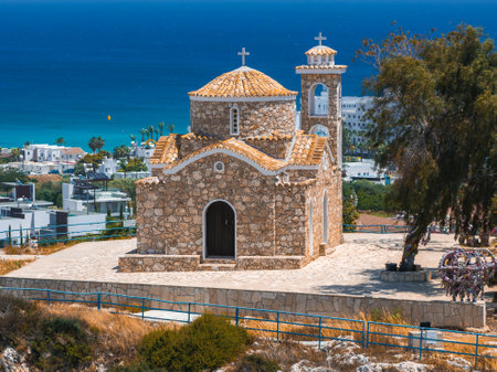 Stone Church with Dome and Bell Tower Overlooking the Sea in Ayia Napaの写真素材
