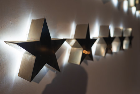 Illuminated Black Star Shaped Wall Decorations on White Surface