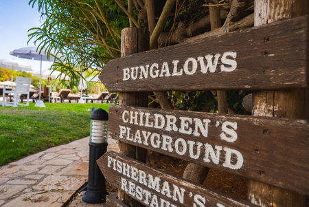 Wooden Signpost in Leisure Area with Pathway and Outdoor Seatingの写真素材