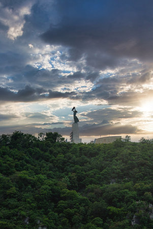 Liberty Statue on Gellert Hill in Budapest with Dramatic Skyの写真素材