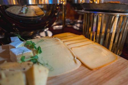 Close Up of Elegant Cheese Platter with Assorted Cheeses and Herbsの写真素材