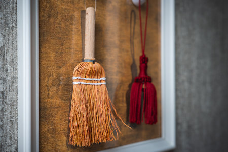 Framed Decorative Display with Straw Broom and Red Tassel