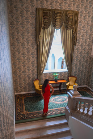 Elegant Boutique Hotel Interior with Grand Staircase and Seating Areaの写真素材