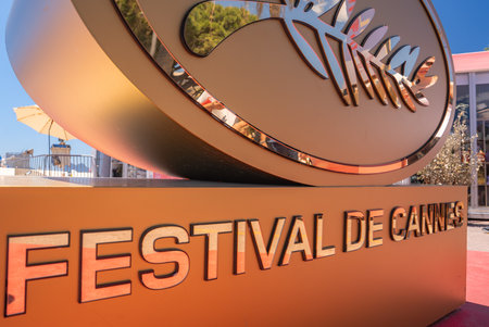 Close Up of Festival de Cannes Sign with Red Carpet in Background