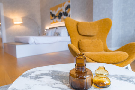 Modern Hotel Interior with Marble Table and Mustard Armchairの写真素材