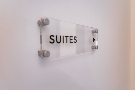 Modern Acrylic Sign with Suites Label and Arrow in Luxury Hotelの写真素材
