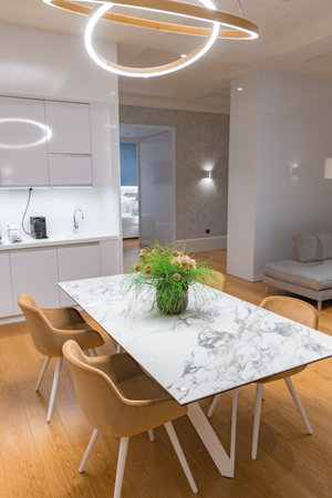Modern Dining Area with Marble Table and Contemporary Lightingの写真素材