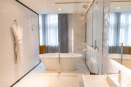 Luxurious Bathroom with Freestanding Bathtub and Glass Showerの写真素材
