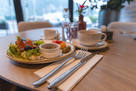 Elegant Dining Table with Gourmet Meal in Luxury Hotel Settingの写真素材