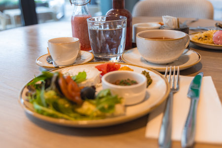 Breakfast Table with Fresh Ingredients in a Modern Hotel Interiorの写真素材