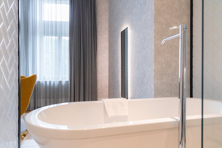 Luxurious Bathroom with Freestanding Bathtub and Natural Lightの写真素材
