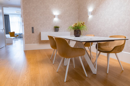 Modern Dining Area with Marble Table and Mustard Yellow Chairsの写真素材